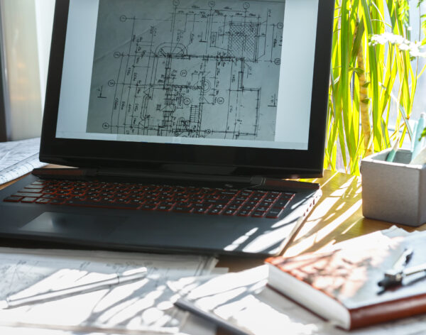 Architect works remotely from home in quarantine, lockdown covid 19 coronavirus. Remote work, stay home, new normality, social distance. Architect design working drawing sketch plans blueprints